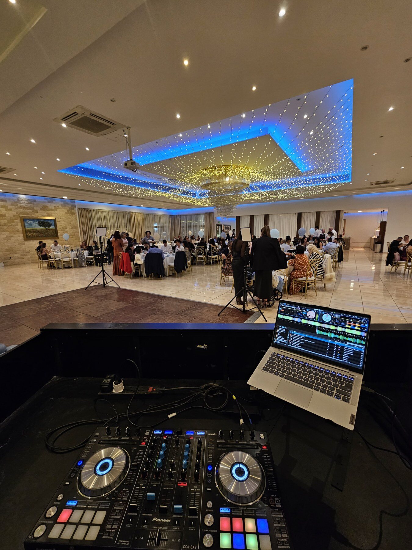 DJ booth overlooking an indoor celebration